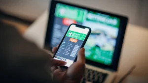 Mature-man-using-mobile-app-for-live-betting-and-online-gambling-and-watching-a-sports-match