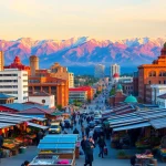 Discover the vibrant cityscape of Almaty at sunset at https://albmaftoh.com with mountains in the background.