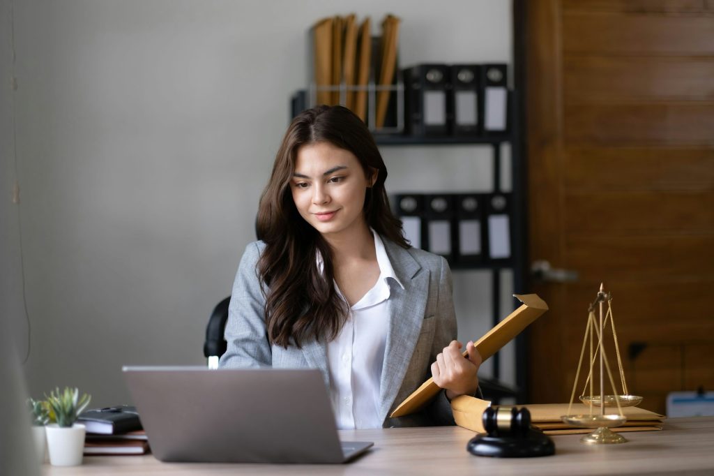 asian-lawyer-woman-working-with-a-laptop-computer-in-a-law-office-legal-and-legal-service-concept-