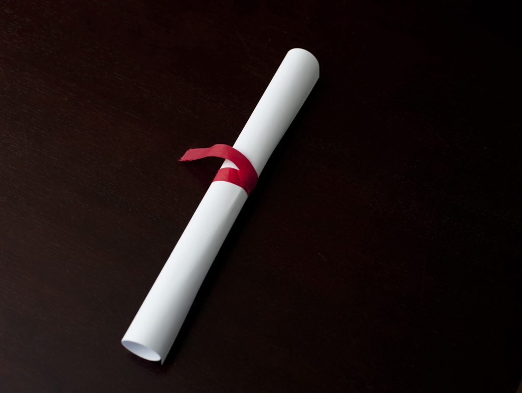 Rolled diploma tied with ribbon