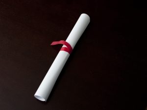 Rolled diploma tied with ribbon