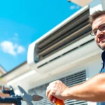 Efficient air conditioning repair Canada service with a technician solving issues at a home.